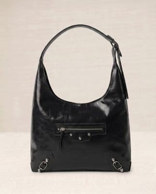 a black handbag sitting on top of a table
