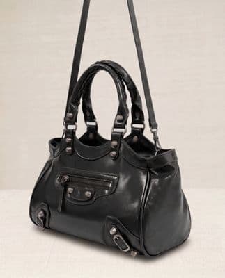 a black handbag with two straps hanging from it