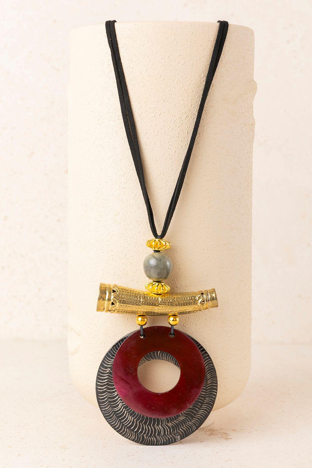 a necklace with a wooden object on it