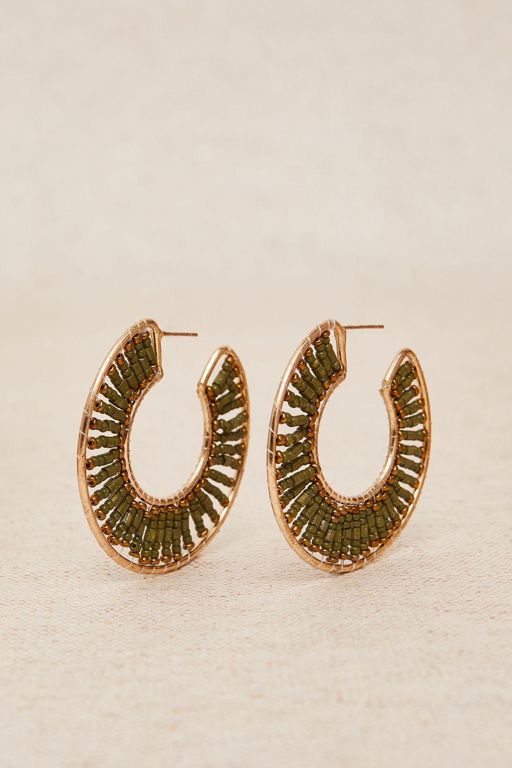 a pair of gold hoop earrings on a white background