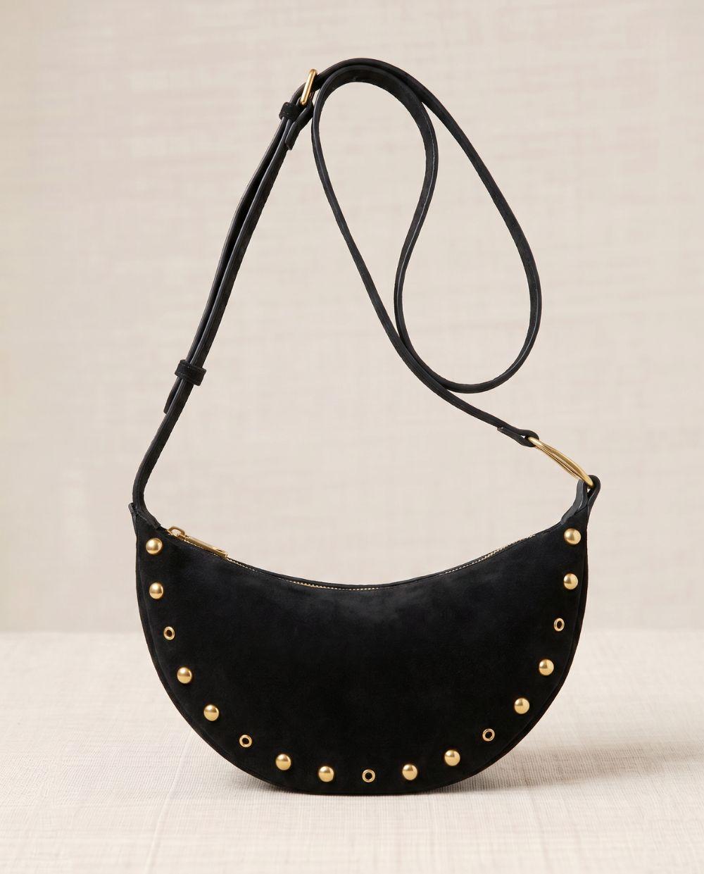 a black purse with gold studded details