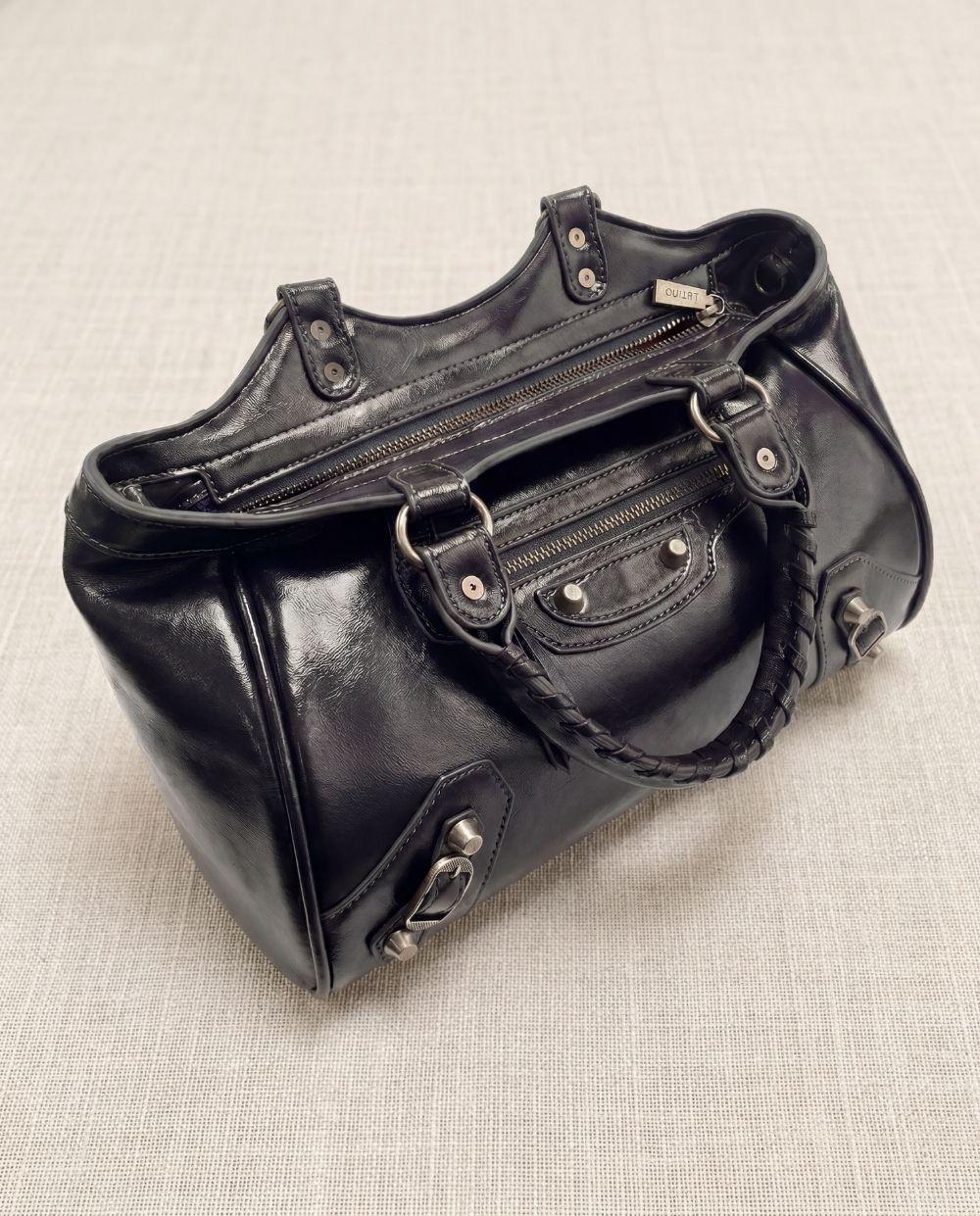a black purse sitting on top of a table