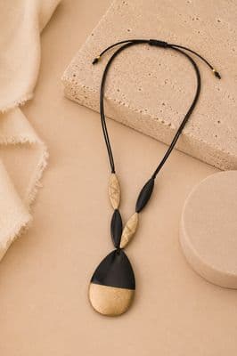 a necklace with a black and gold pendant