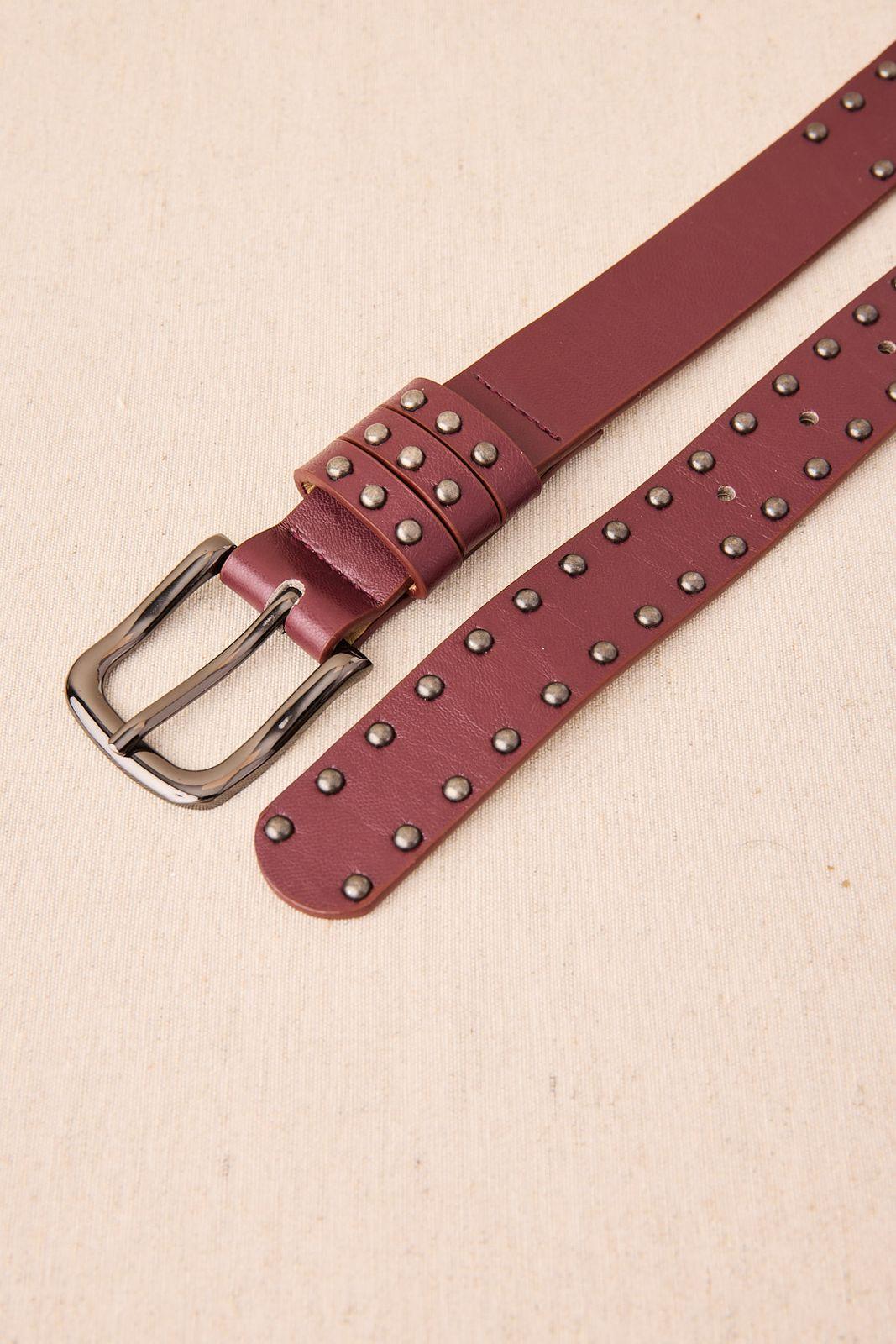 a belt with a metal buckle on a white surface