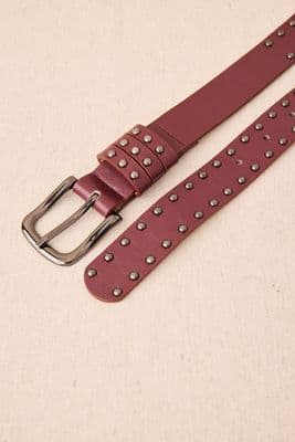 a belt with a metal buckle on a white surface