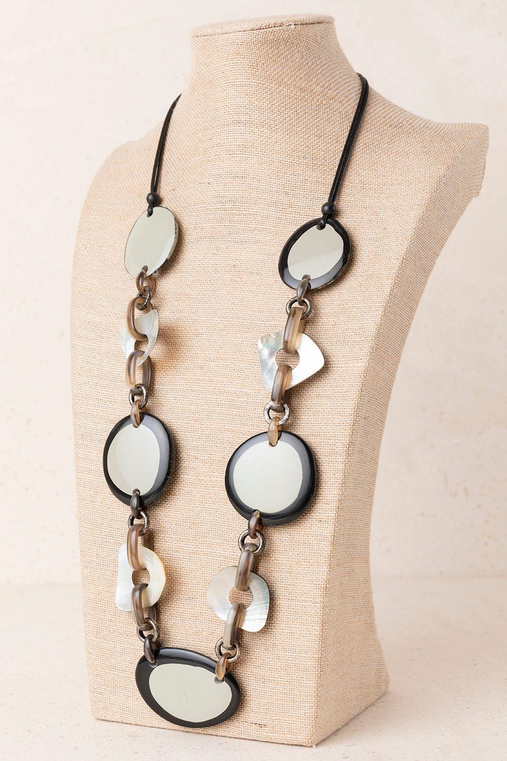 a black and white necklace on a mannequin