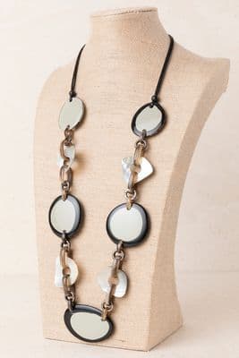 a black and white necklace on a mannequin