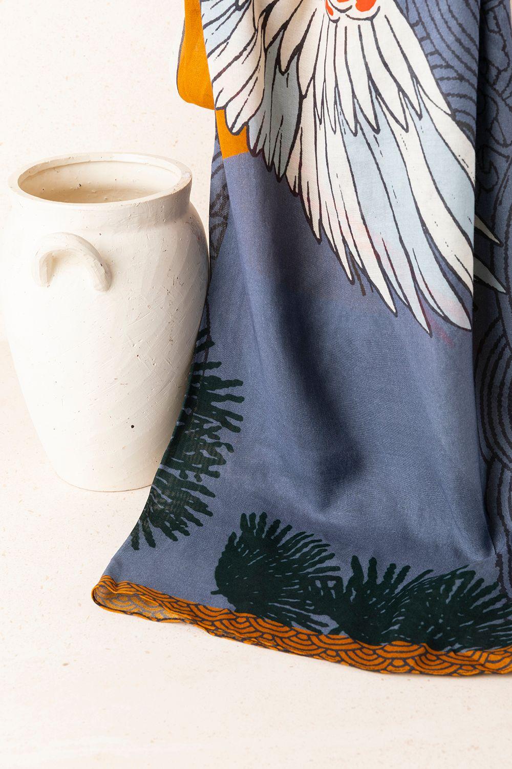 a white cup sitting next to a blue towel