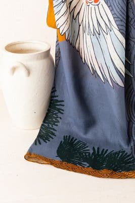 a white cup sitting next to a blue towel
