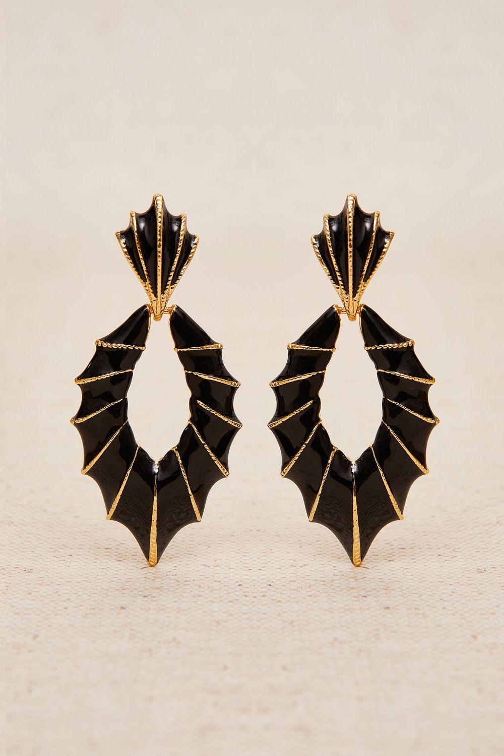 a pair of black and gold earrings