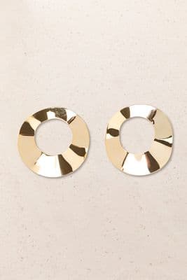 a pair of gold earrings on a white surface