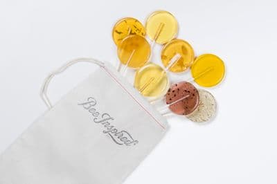 a white bag filled with different colored pills