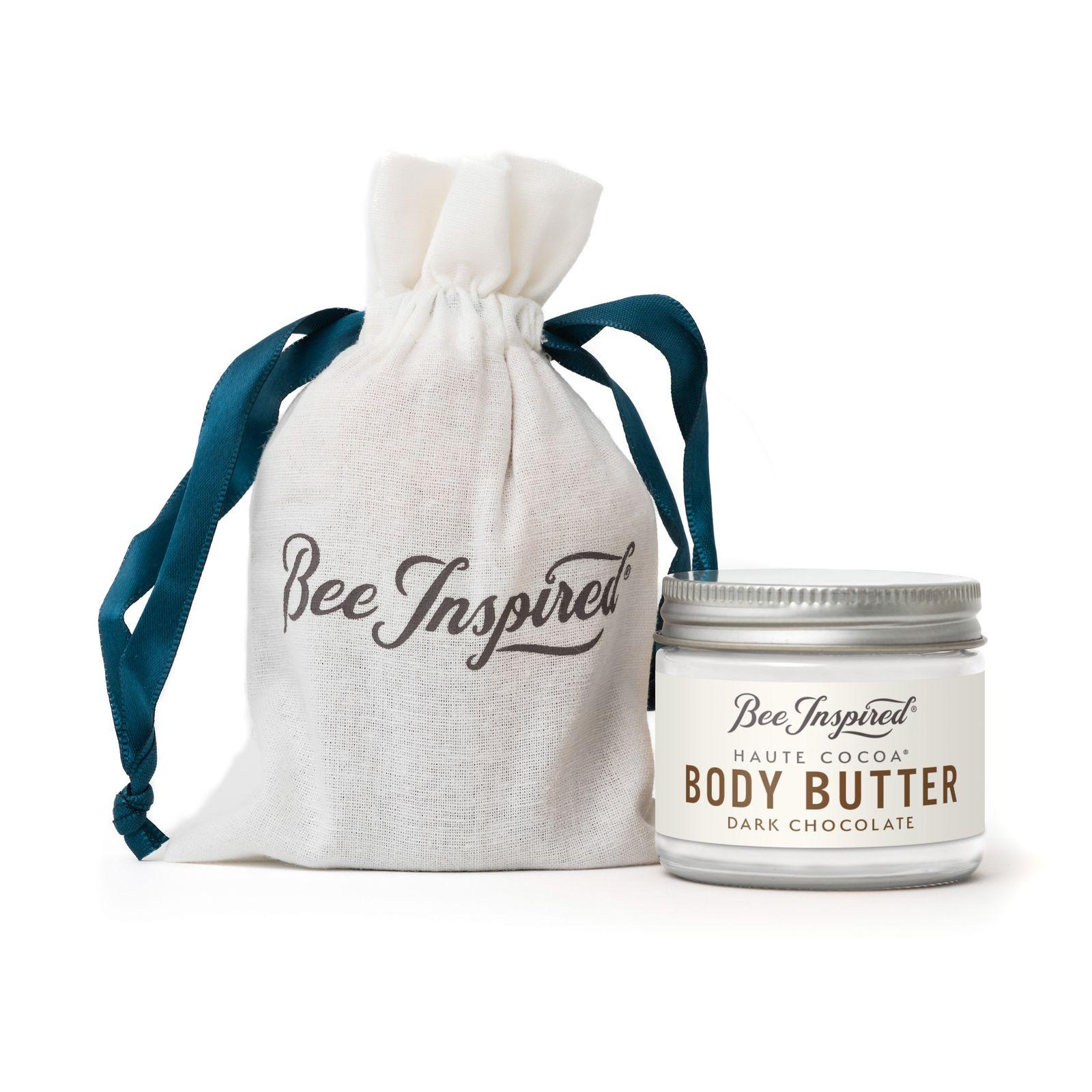 a jar of body butter next to a bag