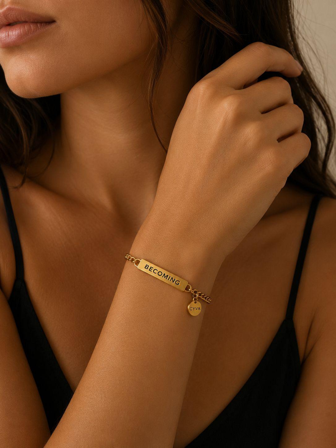 a close up of a woman wearing a gold bracelet