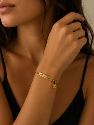 a close up of a woman wearing a gold bracelet