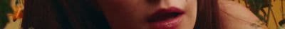 a blurry photo of a woman's face with red lipstick