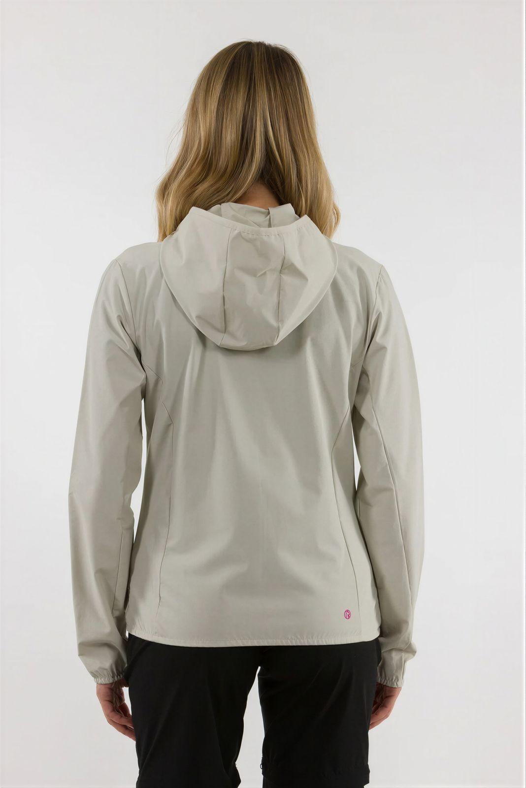 a woman wearing a white jacket and black pants
