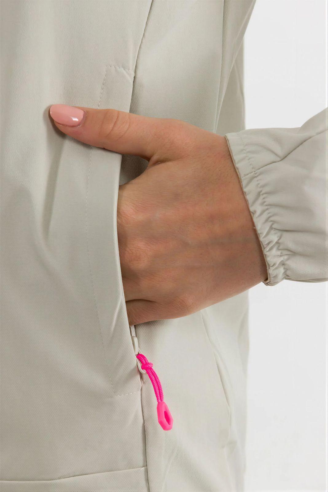 a woman's hand with a pink ring on it
