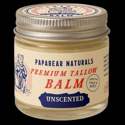 a jar of balm on a black background