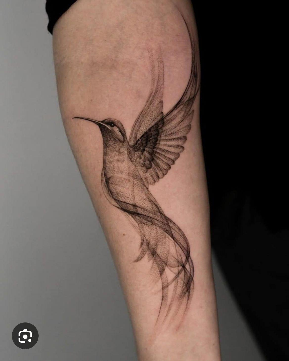 a tattoo of a hummingbird on the arm