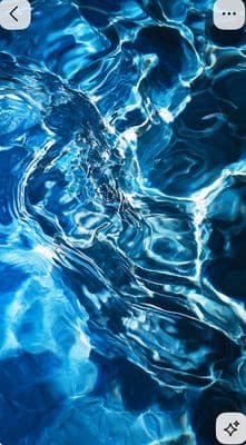 a close up of a cell phone with water