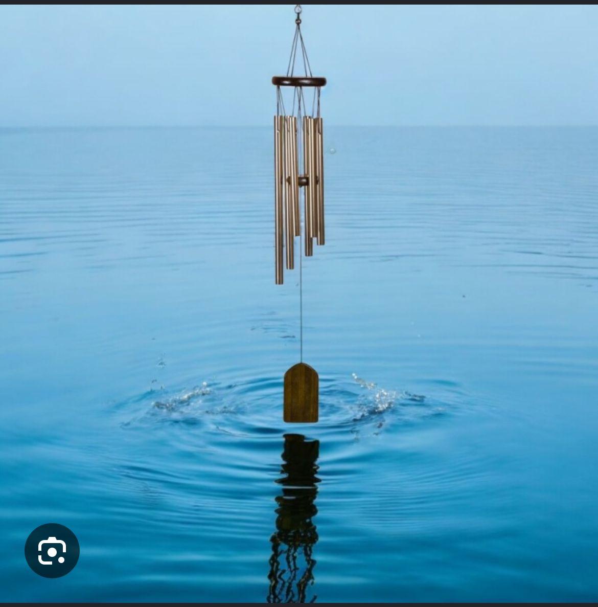 a wind chime in the middle of a body of water