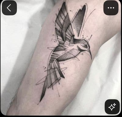 a black and white bird tattoo on the leg