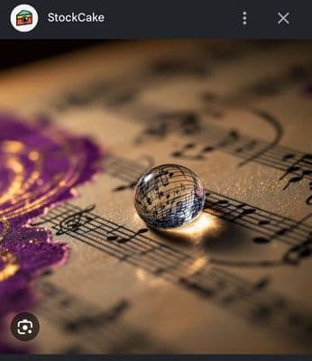 a close up of a glass ball on a sheet of music
