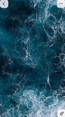 a cell phone with a picture of waves on the screen