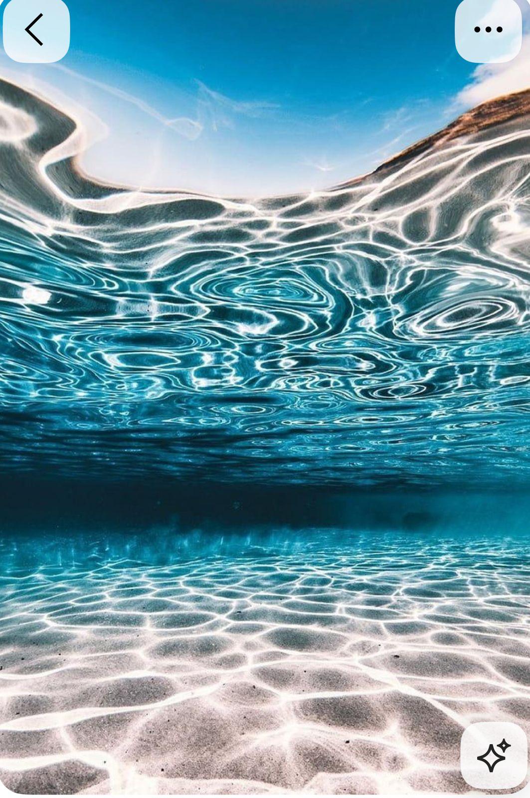 an underwater view of the water and sand