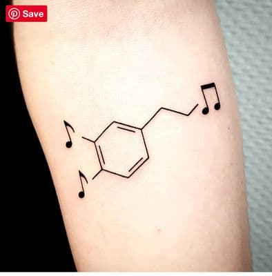 a black and white photo of a music note tattoo