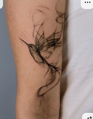 a tattoo of a bird on the arm