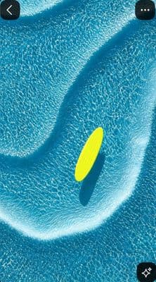 a yellow frisbee floating in a pool of water