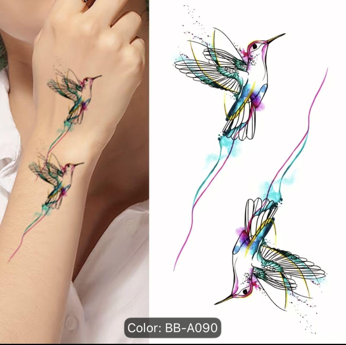 a woman with a tattoo of a hummingbird on her arm