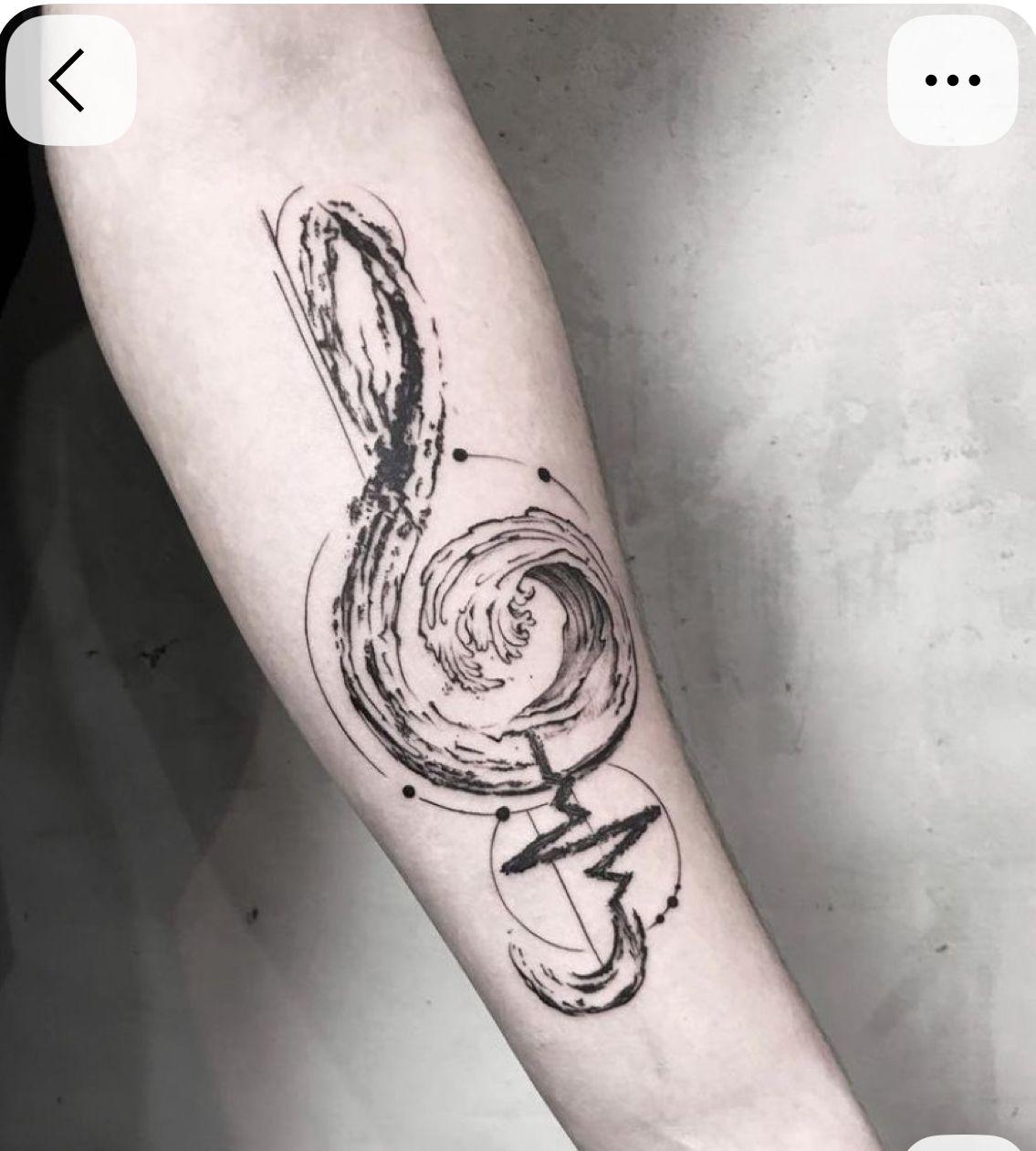 a black and white tattoo of a musical note