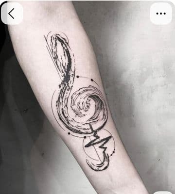 a black and white tattoo of a musical note