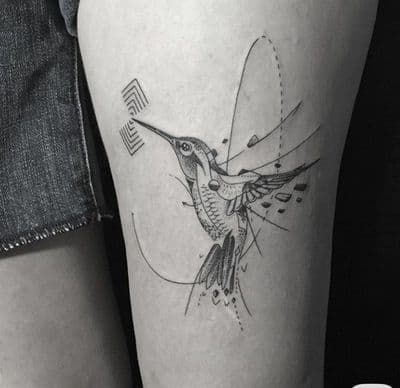 a tattoo of a hummingbird on the thigh