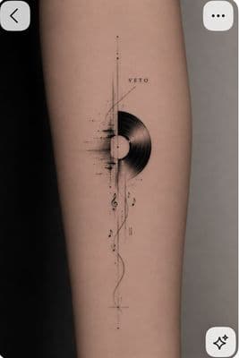 a black and white photo of a person's leg with a record on it