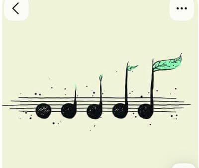 a musical note with a green leaf on it