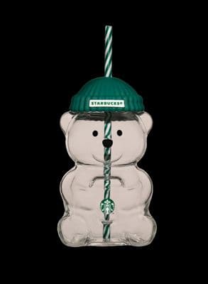 a glass bear with a starbucks hat and a candy cane