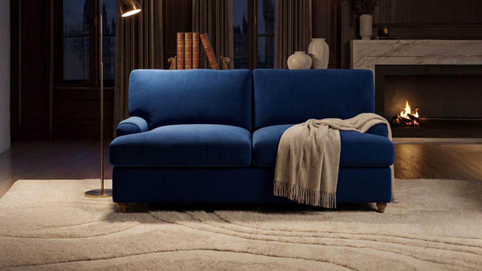 a blue couch sitting in a living room next to a fire place