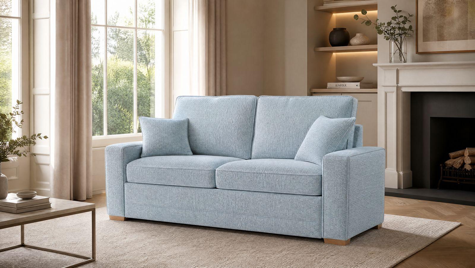 a living room with a blue couch and a fireplace