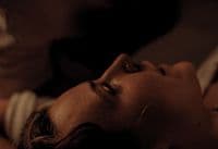 a close up of a person laying on a bed