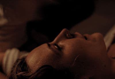 a close up of a person laying on a bed
