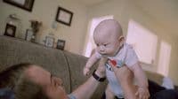 a man holding a baby up to his face