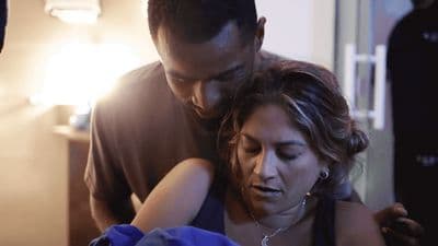 a man and a woman looking at a cell phone