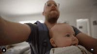 a man holding a baby in his arms