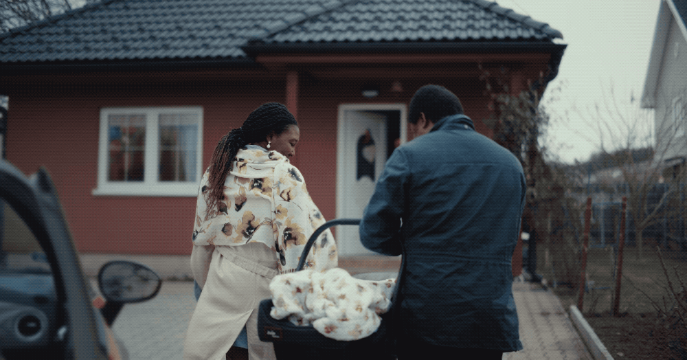 a man and a woman standing outside of a house