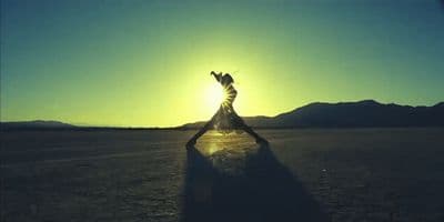 a person standing in the middle of a desert