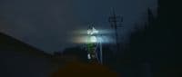 a person standing on top of a roof under a street light